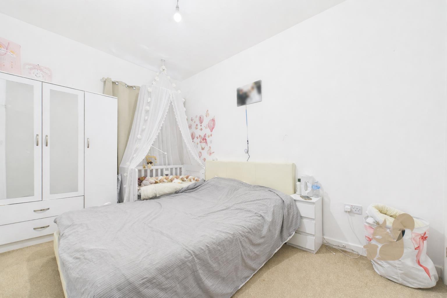 Tidy bedroom with canopy crib.png